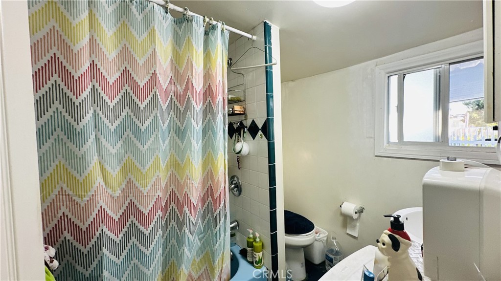 14352 Beach, Unit 95 Westminster, CA 92683 - Photo 2 of 12 a bathroom with a sink and mirror with toilet