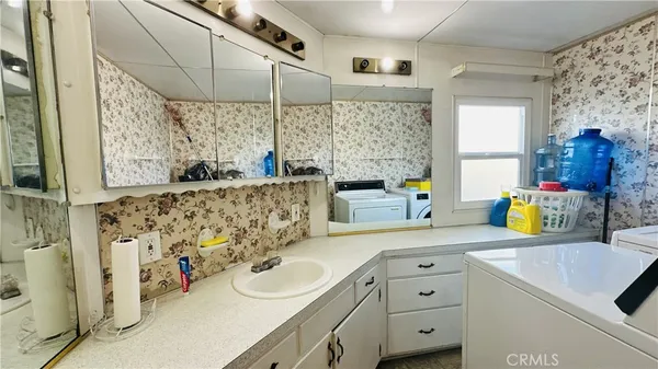 a bathroom with a sink vanity and a mirror