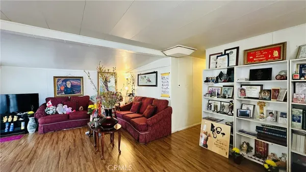 a living room with furniture and a book shelf