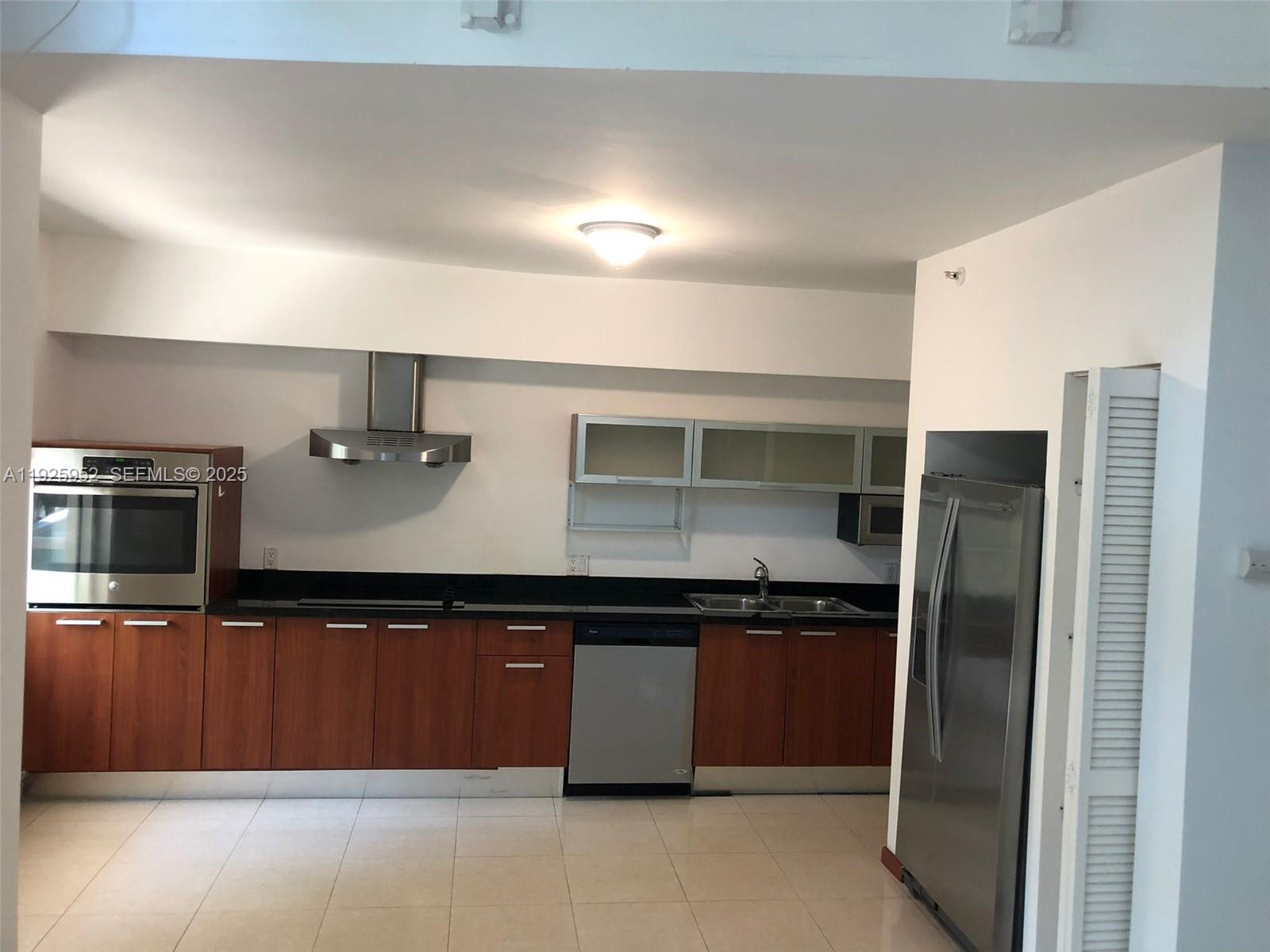 1650 Brickell Avenue, Unit 111 Miami, FL 33129 - Photo 12 of 23 a kitchen with stainless steel appliances a refrigerator and a stove