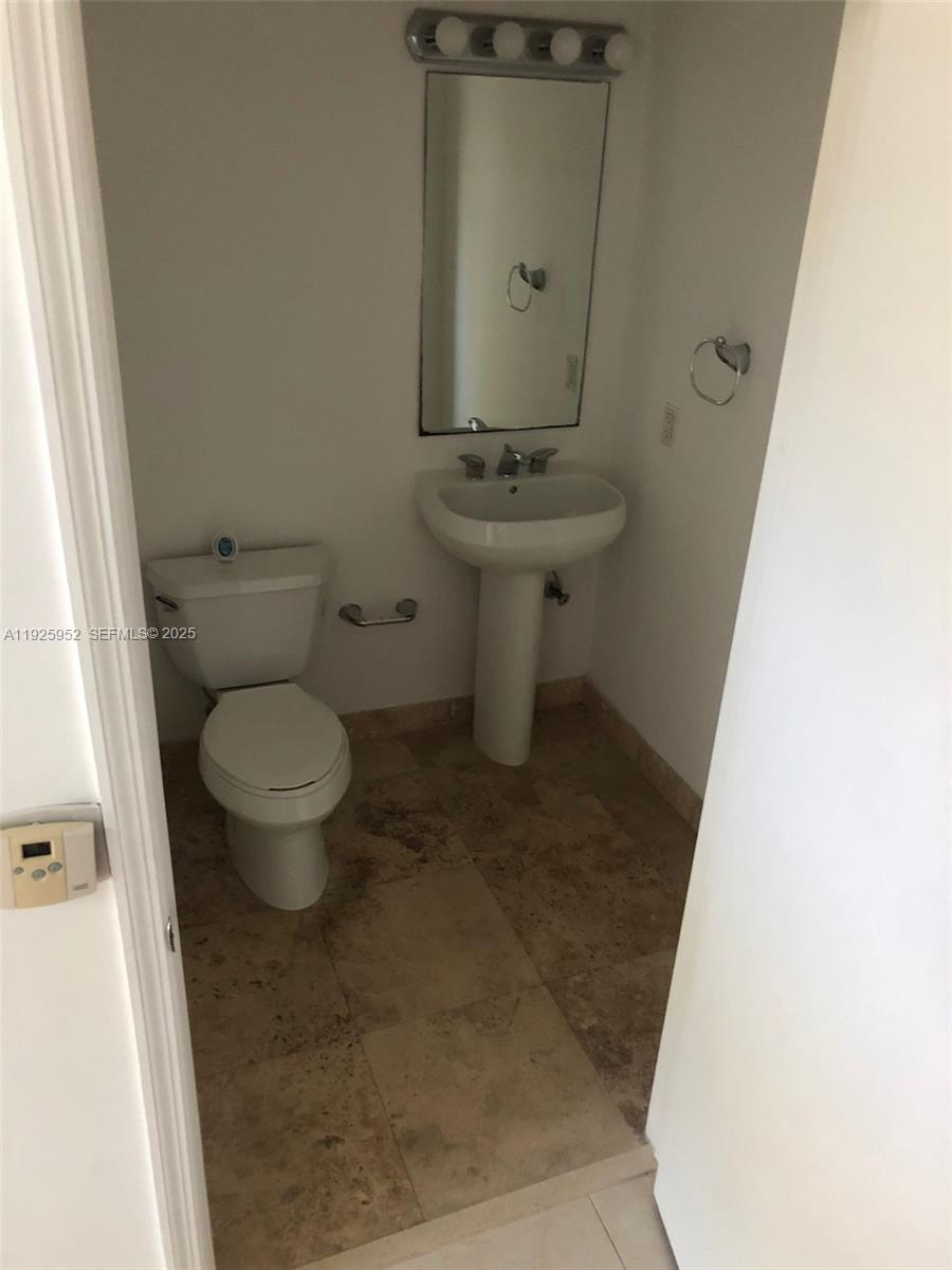 1650 Brickell Avenue, Unit 111 Miami, FL 33129 - Photo 21 of 23 a bathroom with a sink and a toilet