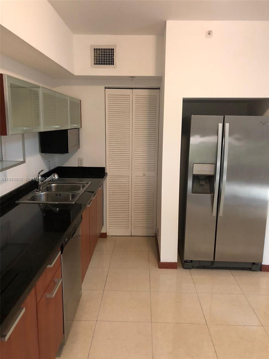1650 Brickell Avenue, Unit 111 Miami, FL 33129 - Photo 4 of 23 a kitchen with granite countertop a refrigerator and a stove