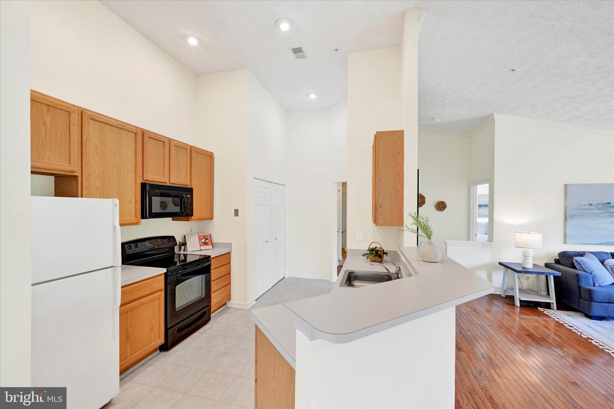 13 Brook Farm Court, Unit 13L Perry Hall, MD 21128 - Photo 11 of 31 a kitchen with granite countertop a sink stainless steel appliances and cabinets