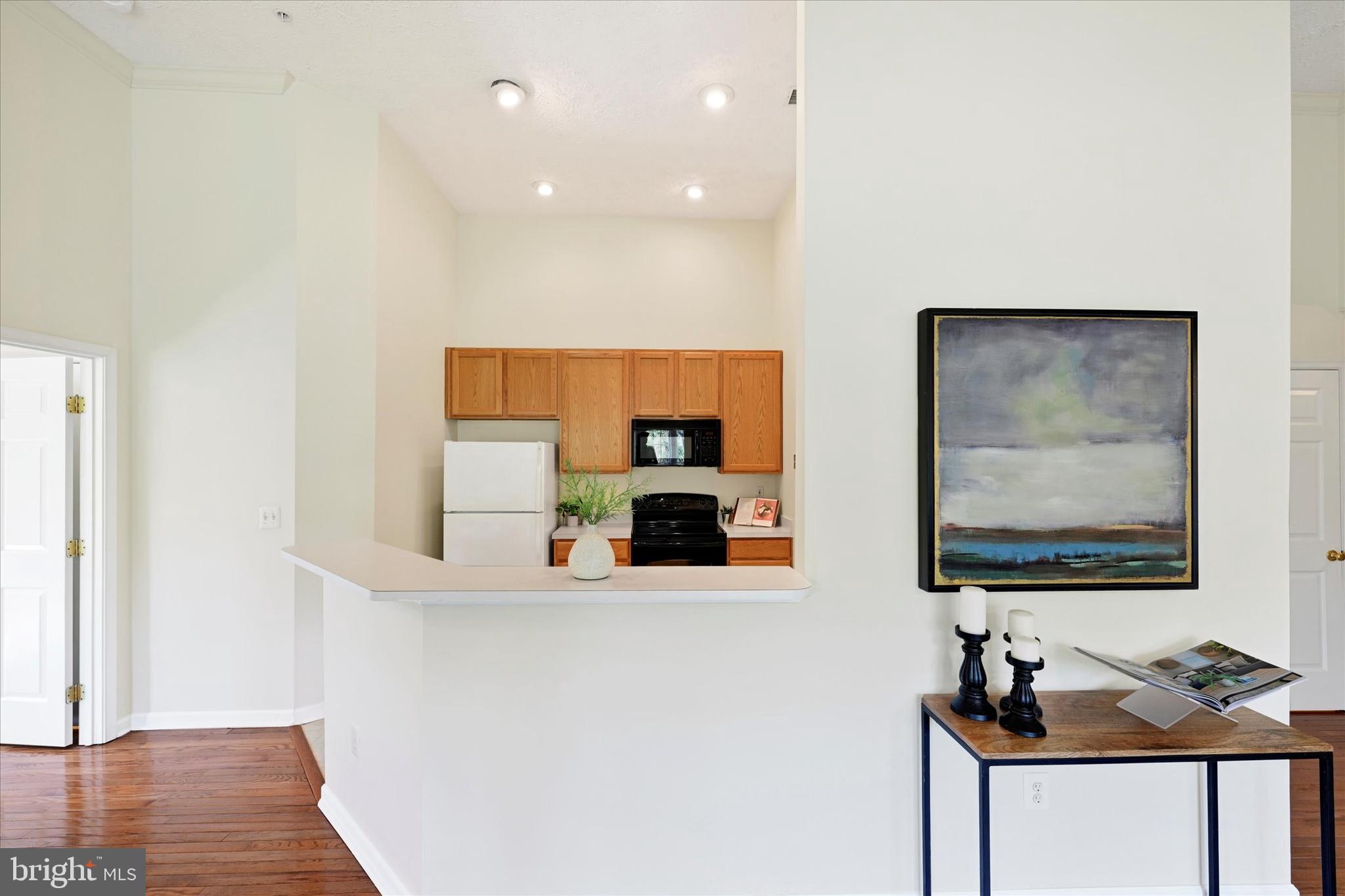 13 Brook Farm Court, Unit 13L Perry Hall, MD 21128 - Photo 12 of 31 a room with wooden floor and mirror