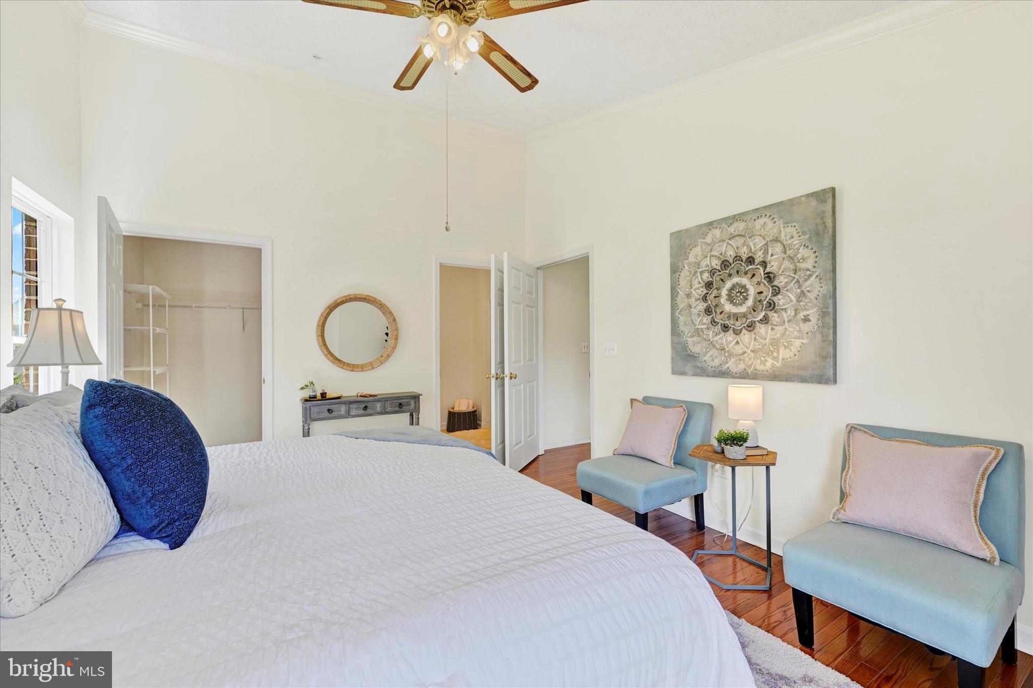 13 Brook Farm Court, Unit 13L Perry Hall, MD 21128 - Photo 15 of 31 a bedroom with a bed a chandelier and a window