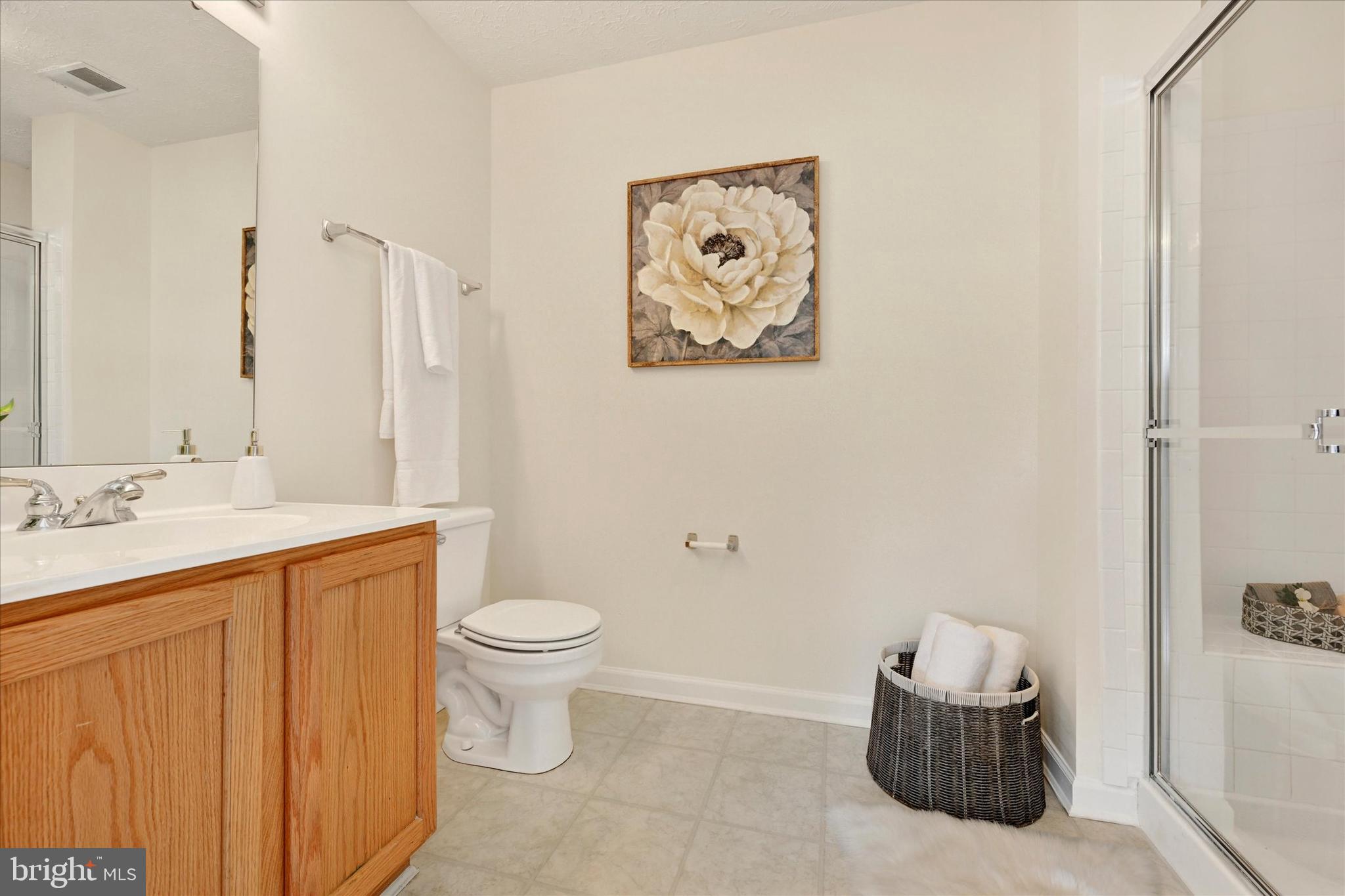13 Brook Farm Court, Unit 13L Perry Hall, MD 21128 - Photo 16 of 31 a bathroom with a toilet sink and mirror