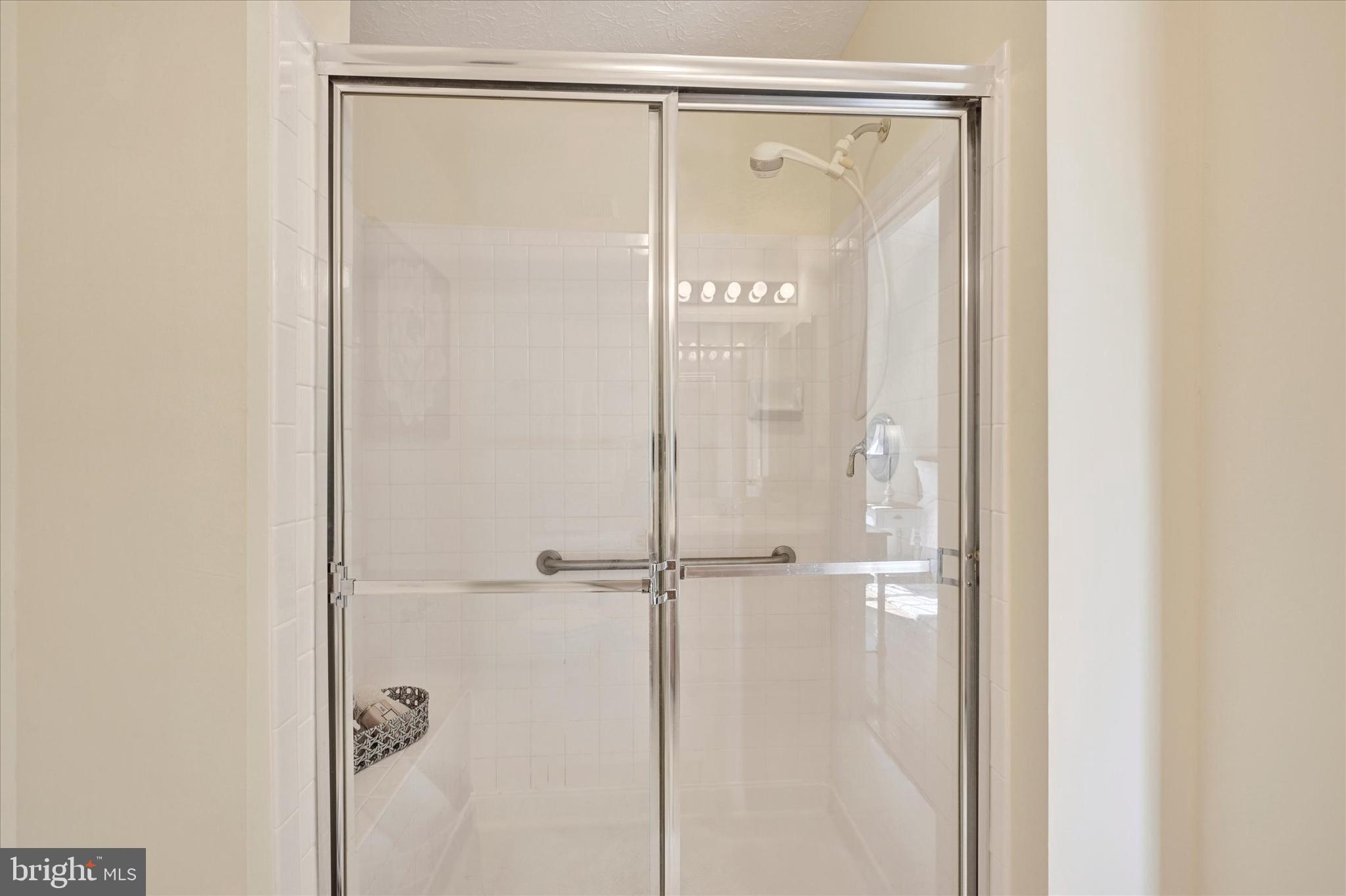 13 Brook Farm Court, Unit 13L Perry Hall, MD 21128 - Photo 17 of 31 a bathroom with a glass shower door