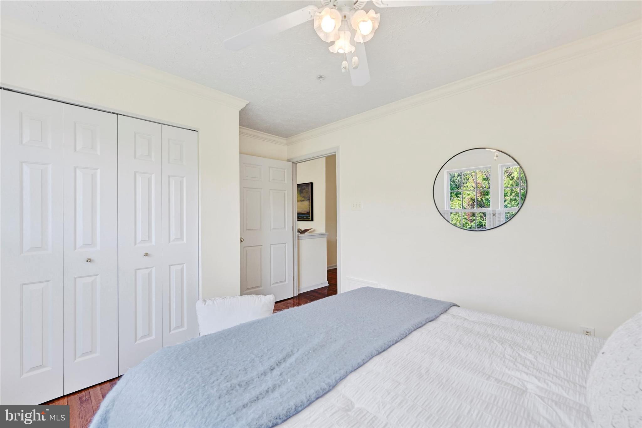 13 Brook Farm Court, Unit 13L Perry Hall, MD 21128 - Photo 19 of 31 a bedroom with a bed and a chandelier