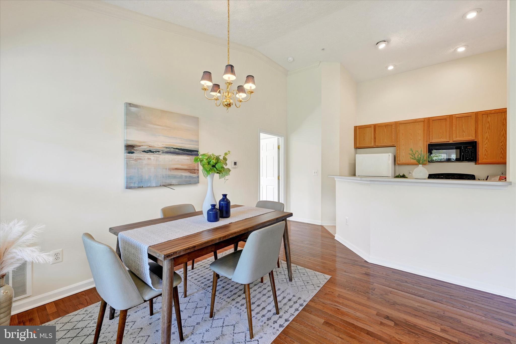 13 Brook Farm Court, Unit 13L Perry Hall, MD 21128 - Photo 9 of 31 a view of a dining room with furniture and wooden floor
