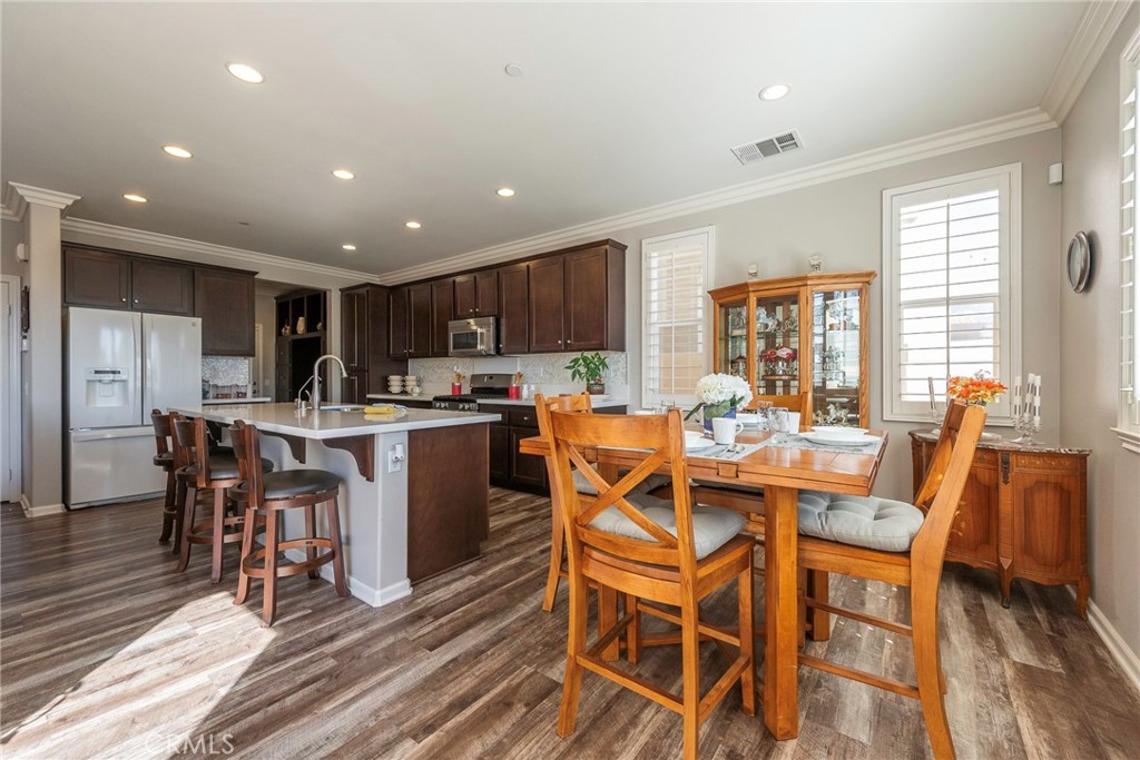 33837 Cansler Way Yucaipa, CA 92399 - Photo 13 of 49 a view of a dining room with furniture window and wooden floor