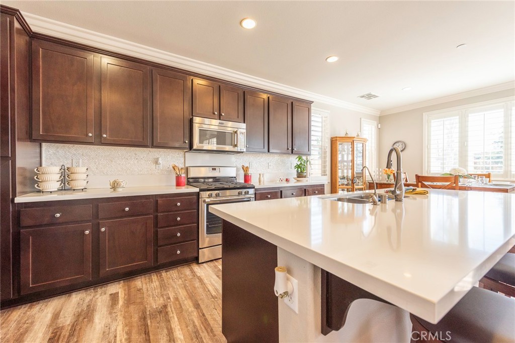 33837 Cansler Way Yucaipa, CA 92399 - Photo 16 of 49 a kitchen with a sink cabinets and window