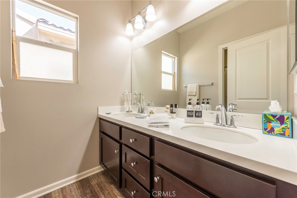 33837 Cansler Way Yucaipa, CA 92399 - Photo 22 of 49 a bathroom with a sink a vanity and a mirror