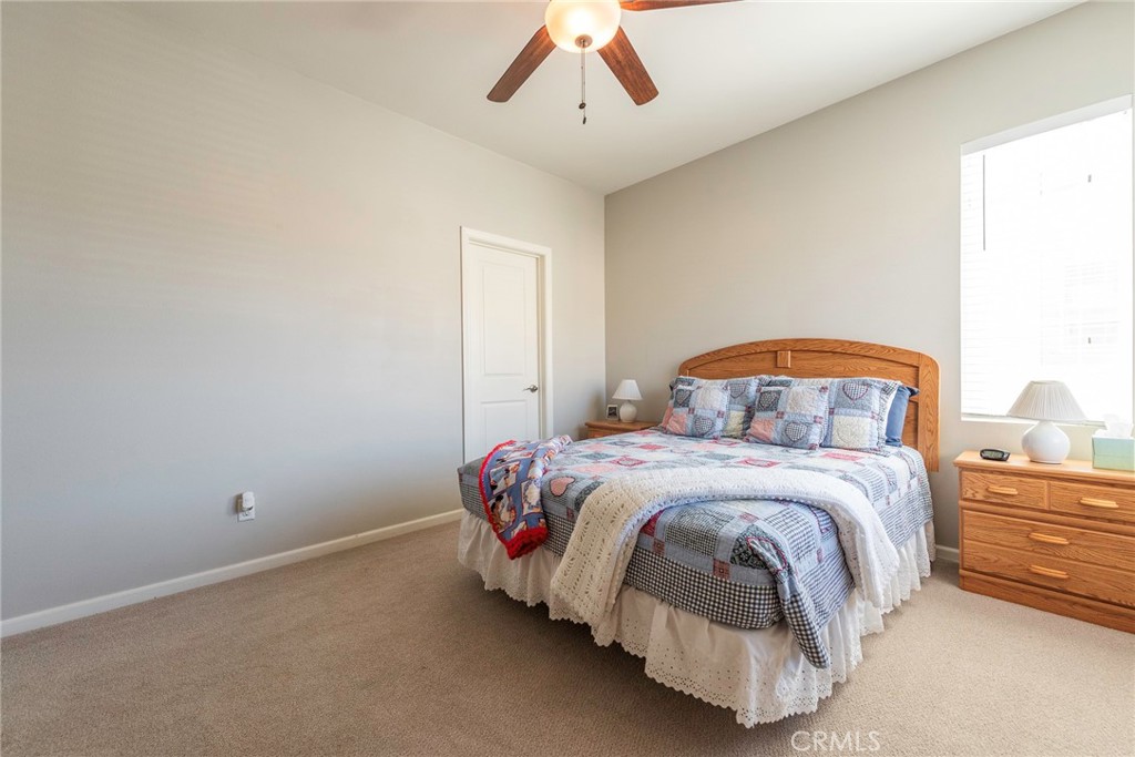 33837 Cansler Way Yucaipa, CA 92399 - Photo 25 of 49 a bedroom with a bed and a ceiling fan