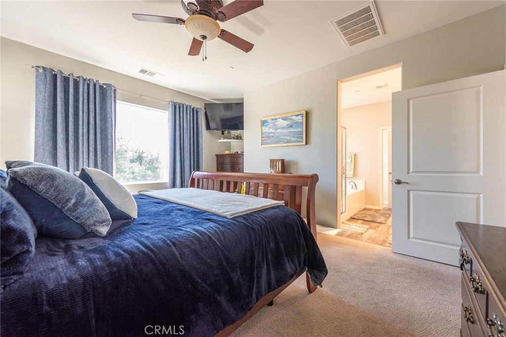 33837 Cansler Way Yucaipa, CA 92399 - Photo 32 of 49 a bed sitting in a bedroom next to a window