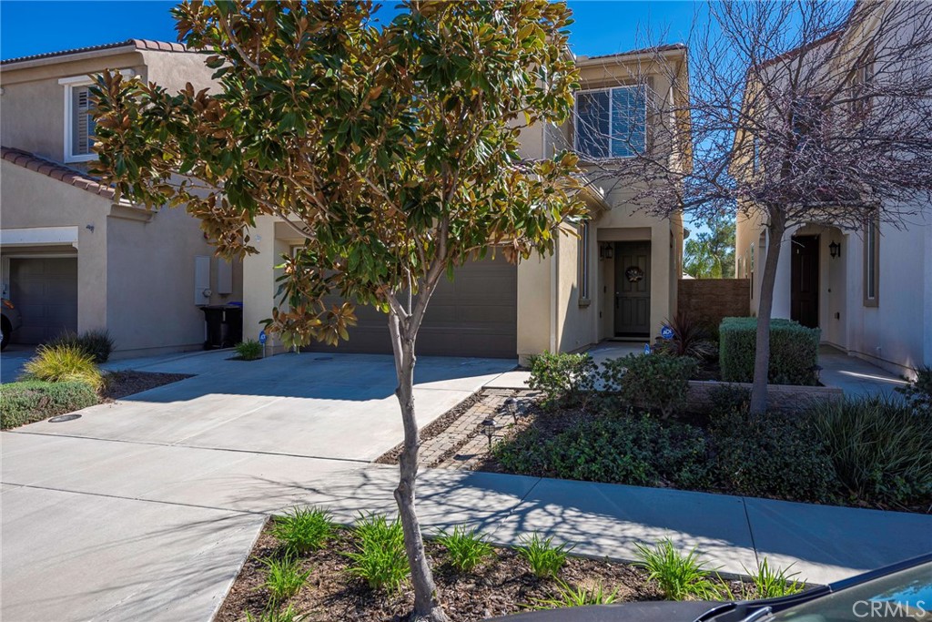 33837 Cansler Way Yucaipa, CA 92399 - Photo 6 of 49 a front view of a house with a yard and flower garden