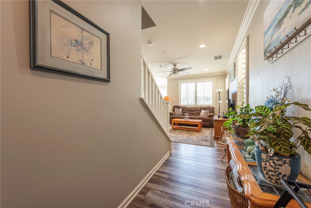 33837 Cansler Way Yucaipa, CA 92399 - Photo 8 of 49 a hallway with wooden floor and furniture