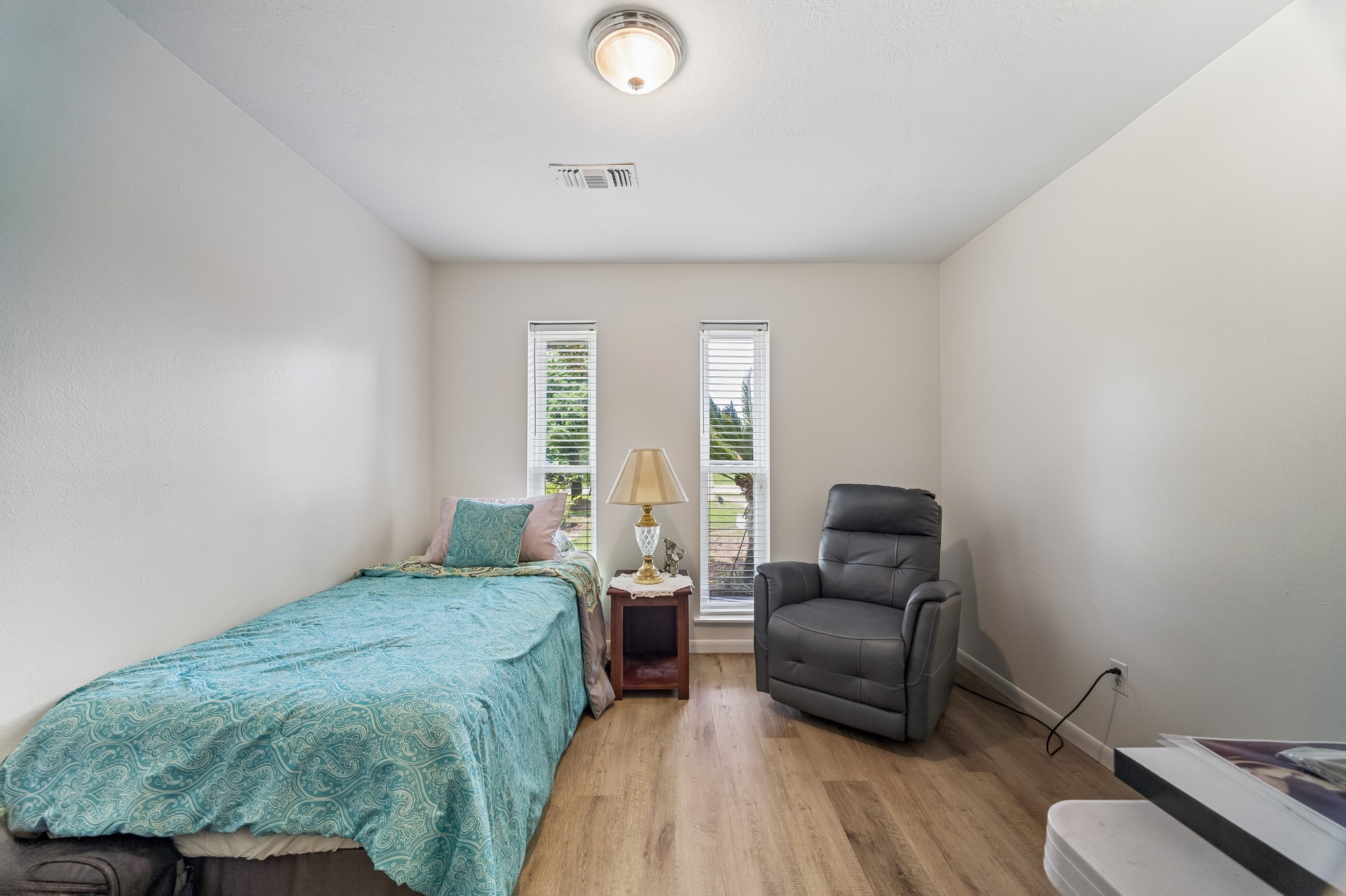 413 Mebane Lane Rosenberg, TX 77471 - Photo 24 of 30 This secondary bedroom has natural light that streams through two vertical windows and also has recently updated flooring.