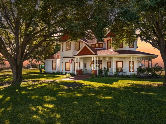 a front view of a house with swimming pool having outdoor seating
