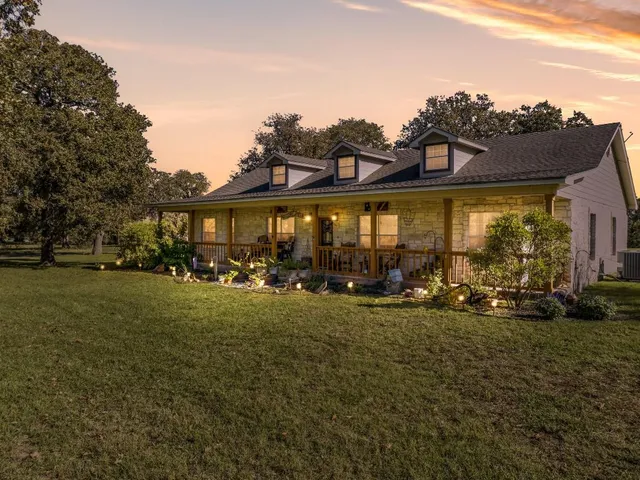 a view of a house with a yard porch and sitting area