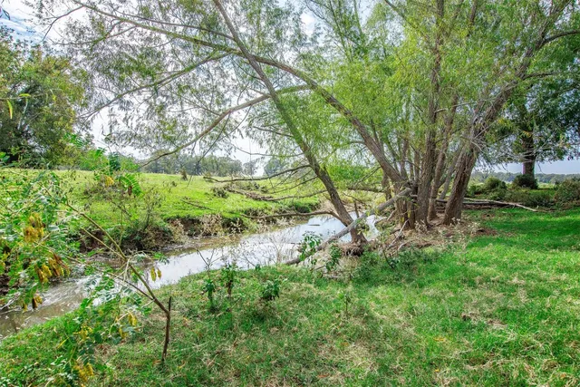 a view of a lake with houses in the back
