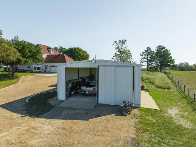 a view of a house with a yard and sitting area