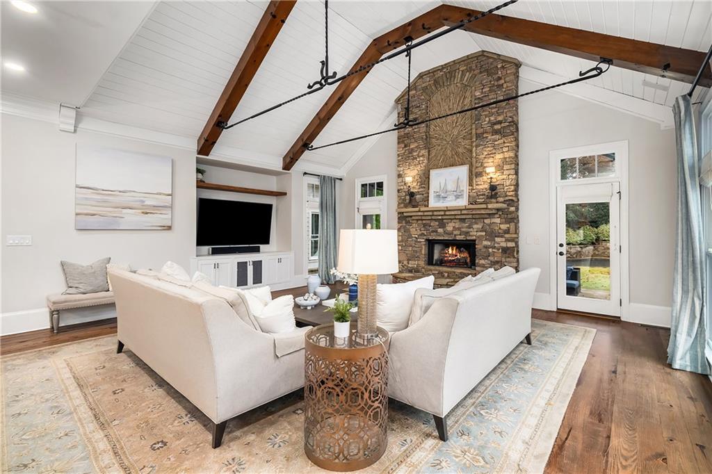 13200 Owens Way Milton, GA 30004 - Photo 20 of 113 a living room with furniture a flat screen tv and a fireplace