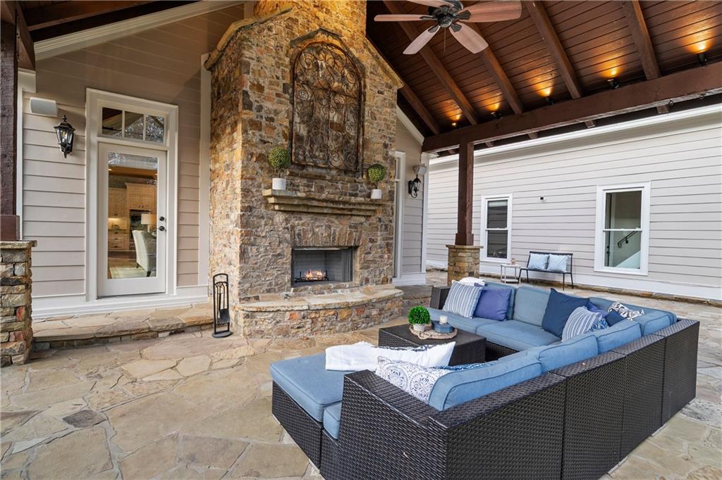 13200 Owens Way Milton, GA 30004 - Photo 26 of 113 a living room with furniture a fireplace and a table