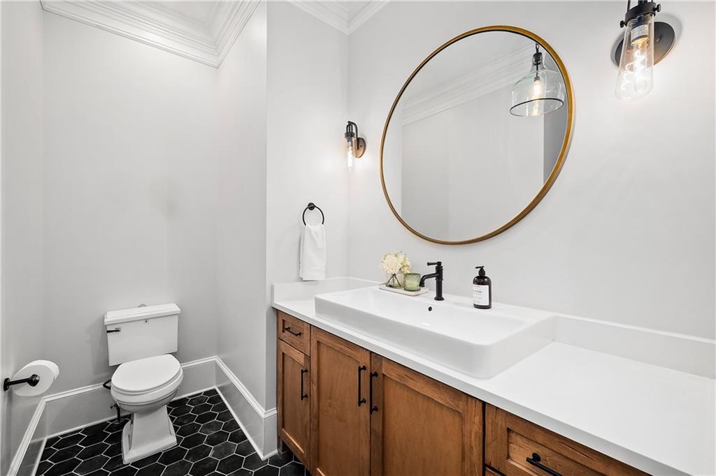13200 Owens Way Milton, GA 30004 - Photo 43 of 113 a bathroom with a sink a toilet and a mirror