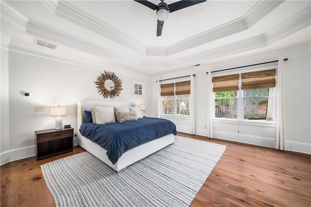 13200 Owens Way Milton, GA 30004 - Photo 46 of 113 a spacious bedroom with a large bed and a chandelier