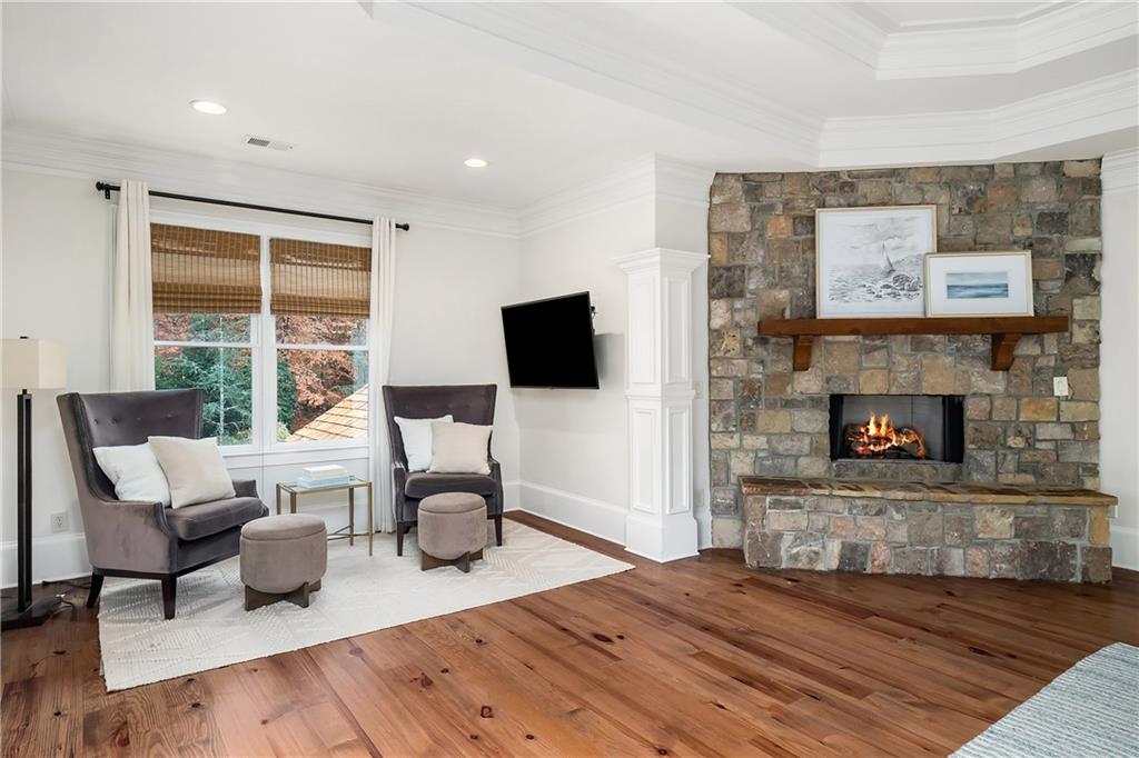 13200 Owens Way Milton, GA 30004 - Photo 48 of 113 a living room with furniture a flat screen tv and a fireplace