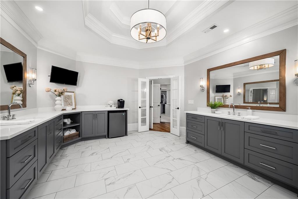 13200 Owens Way Milton, GA 30004 - Photo 49 of 113 a spacious bathroom with a double vanity sink a mirror and a bathtub
