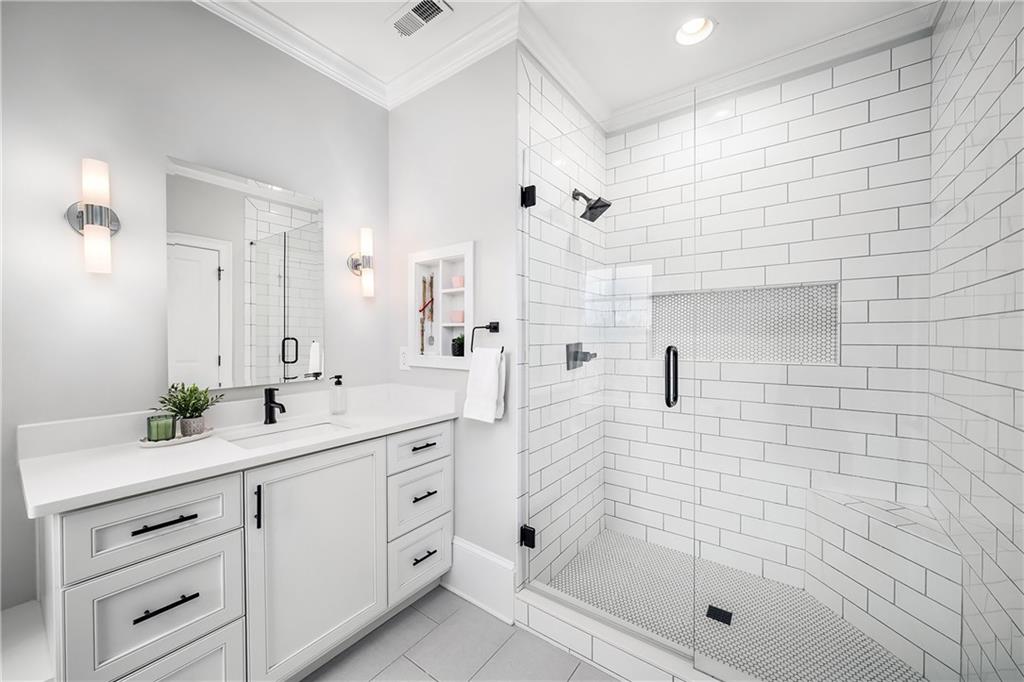 13200 Owens Way Milton, GA 30004 - Photo 55 of 113 a bathroom with a shower sink and mirror