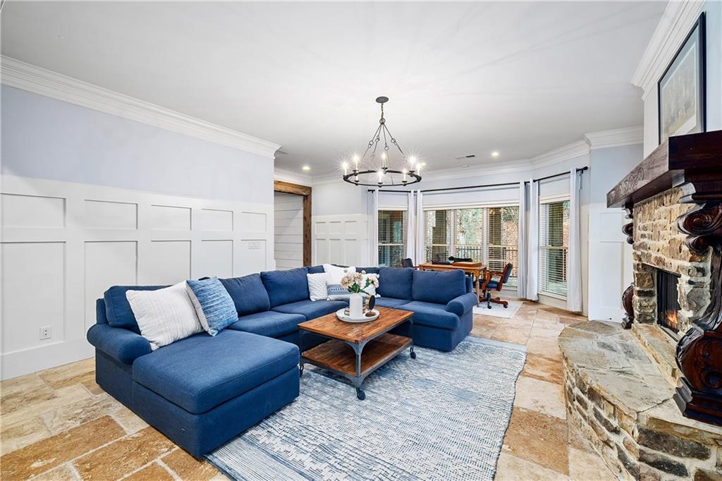 13200 Owens Way Milton, GA 30004 - Photo 62 of 113 a living room with furniture and a chandelier