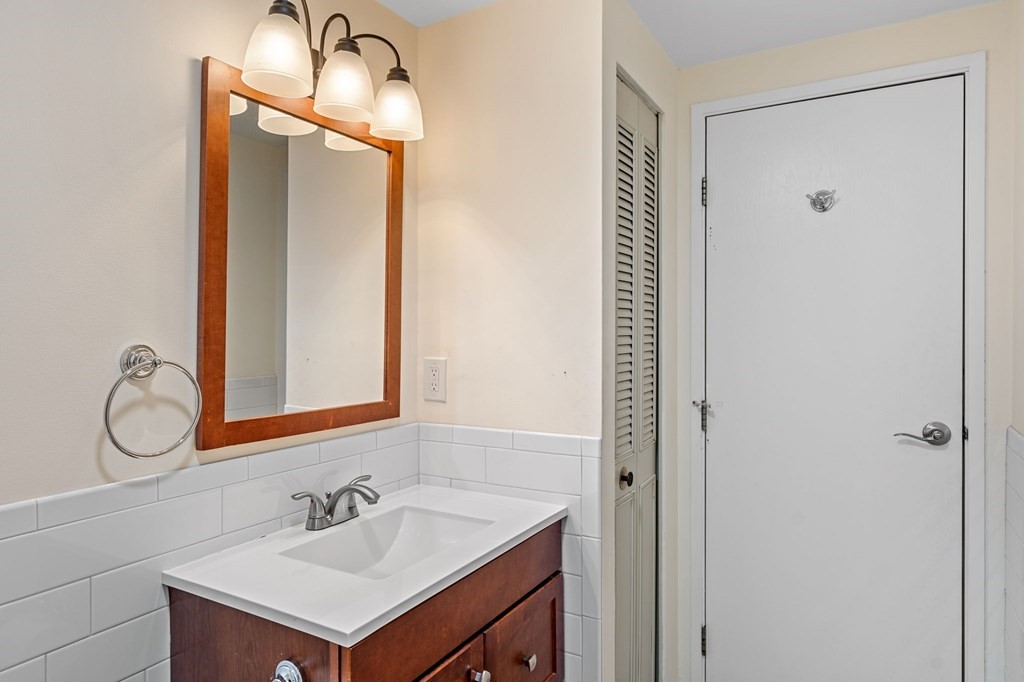 159 Franklin Street, Unit D2 Stoneham, MA 02180 - Photo 18 of 27 a bathroom with a sink and a mirror