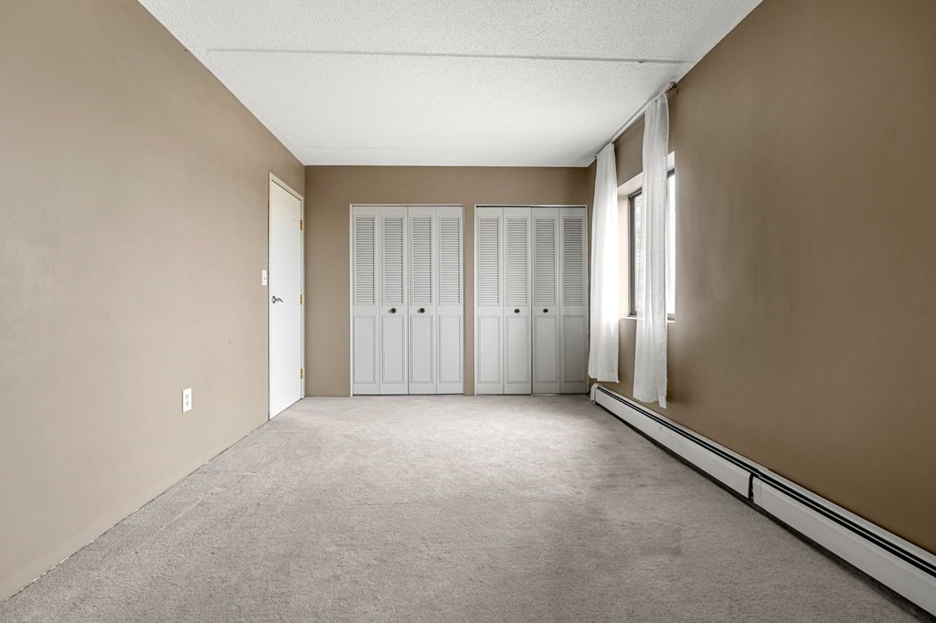 159 Franklin Street, Unit D2 Stoneham, MA 02180 - Photo 20 of 27 an empty room with windows