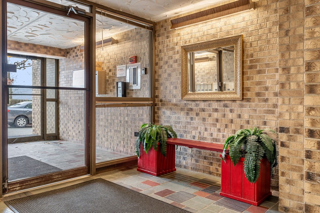 159 Franklin Street, Unit D2 Stoneham, MA 02180 - Photo 27 of 27 a hallway with a potted plant in front of it
