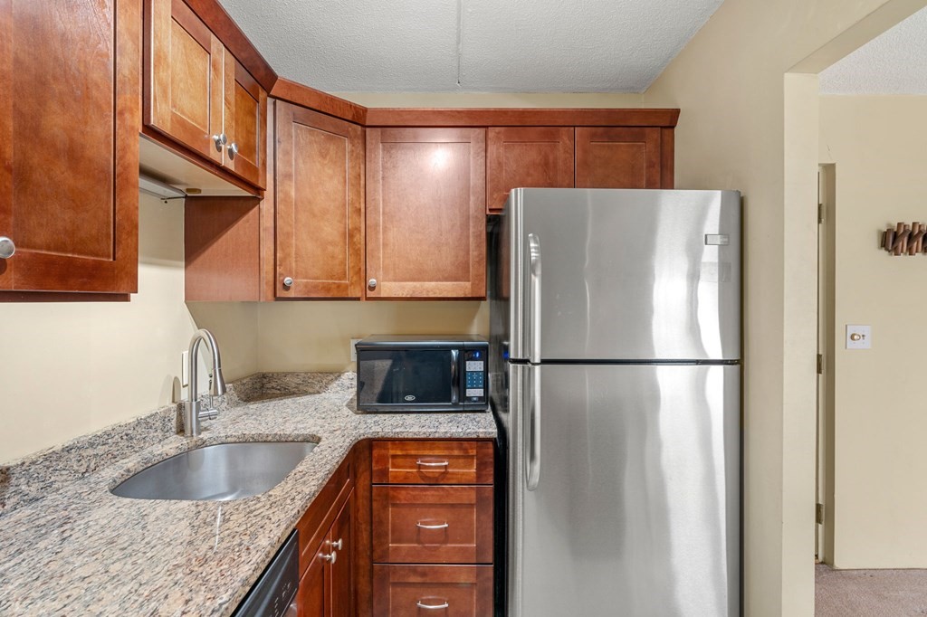 159 Franklin Street, Unit D2 Stoneham, MA 02180 - Photo 8 of 27 a white refrigerator freezer sitting inside of a kitchen