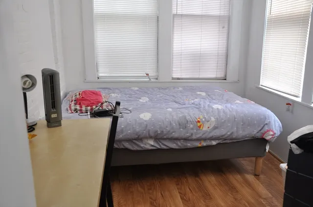 a bedroom with a bed and a dresser