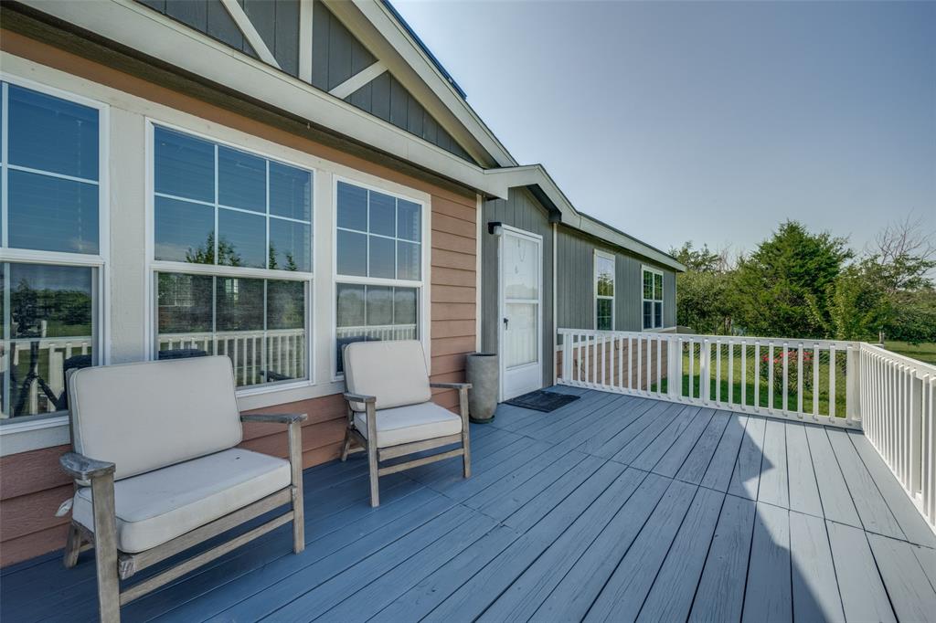 223 Slayden Drive Sunset, TX 76270 - Photo 5 of 24 a balcony with wooden floor and furniture