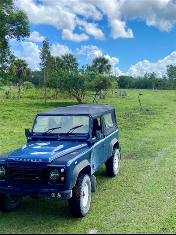 5608 Southwest Cherokee Street Palm City, FL 34990 - Photo 3 of 4 a view of a two chairs in a yard
