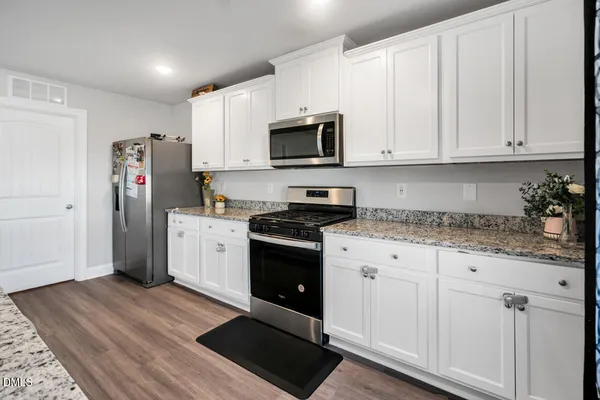 a kitchen with kitchen island granite countertop a sink and a counter top space