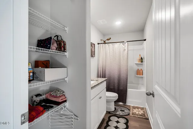 a white bath tub sitting next to a shower