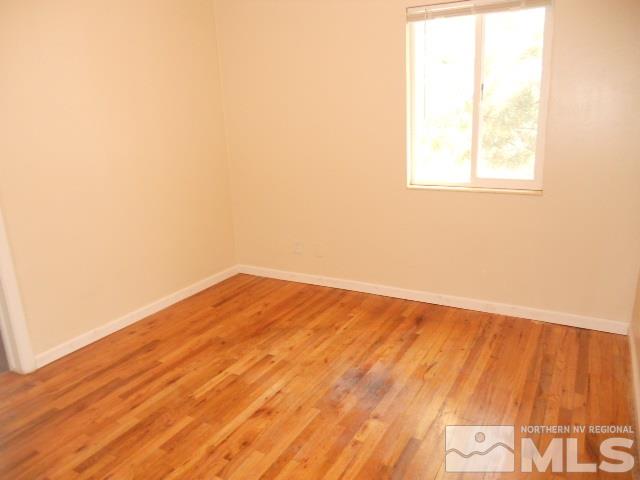 20 Volmer Way Reno, NV 89512 - Photo 12 of 24 an empty room with wooden floor and windows