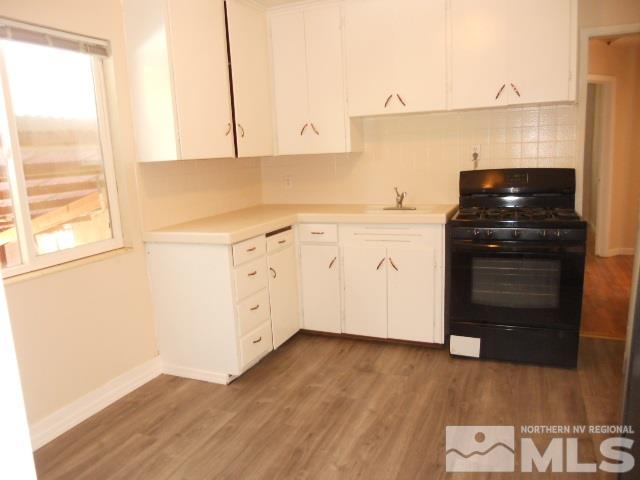 20 Volmer Way Reno, NV 89512 - Photo 7 of 24 a kitchen with granite countertop white cabinets and black appliances