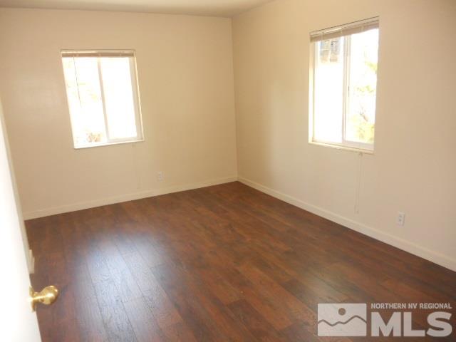 20 Volmer Way Reno, NV 89512 - Photo 9 of 24 an empty room with wooden floor and windows