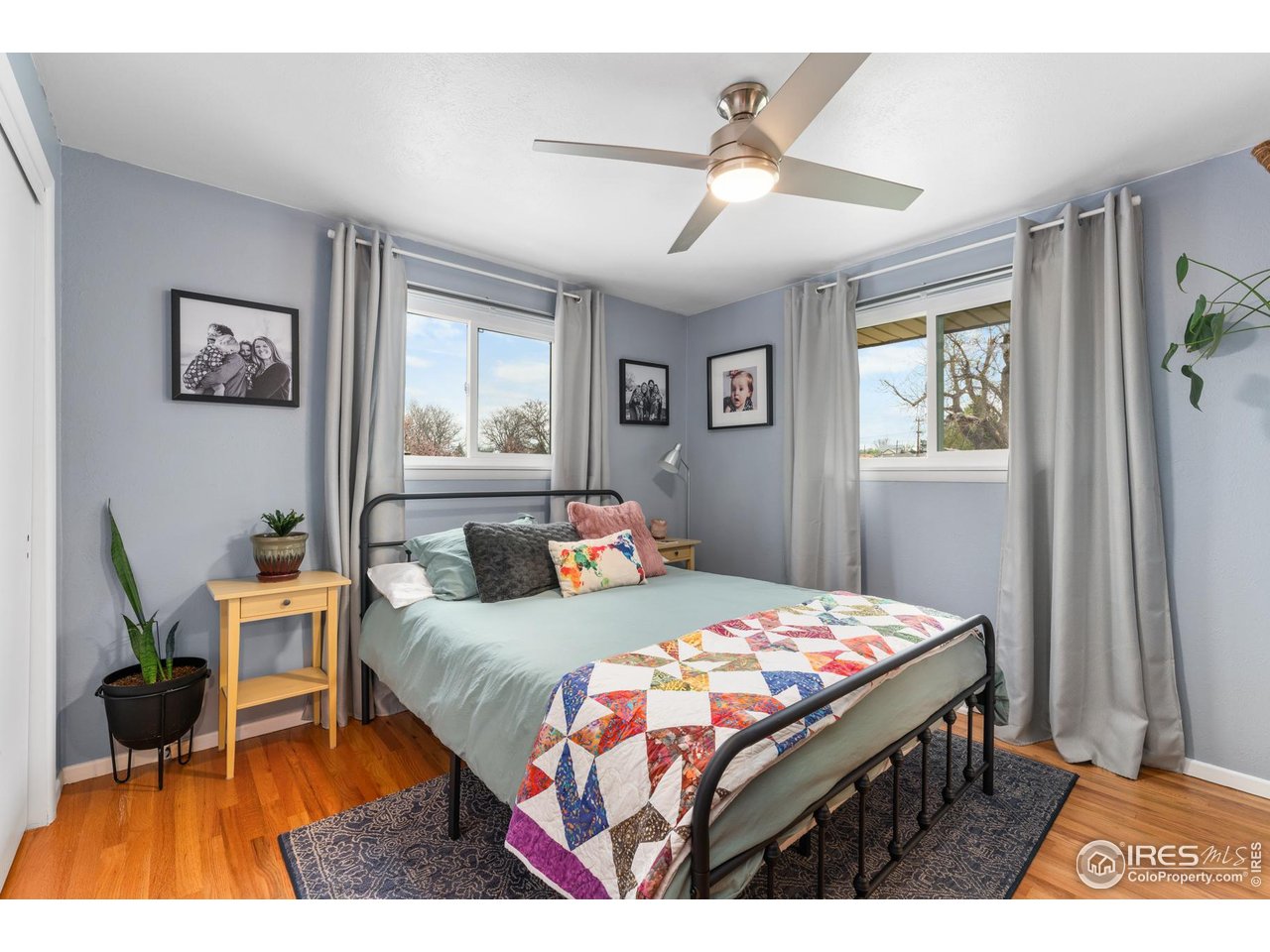 9261 Julian Way Westminster, CO 80031 - Photo 14 of 33 a bedroom with a bed a rug and a window