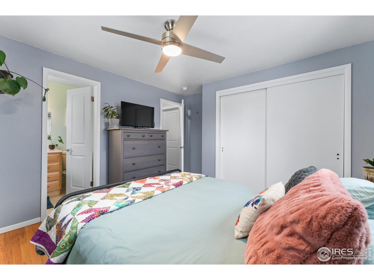 9261 Julian Way Westminster, CO 80031 - Photo 15 of 33 a bedroom with a bed and a flat screen tv