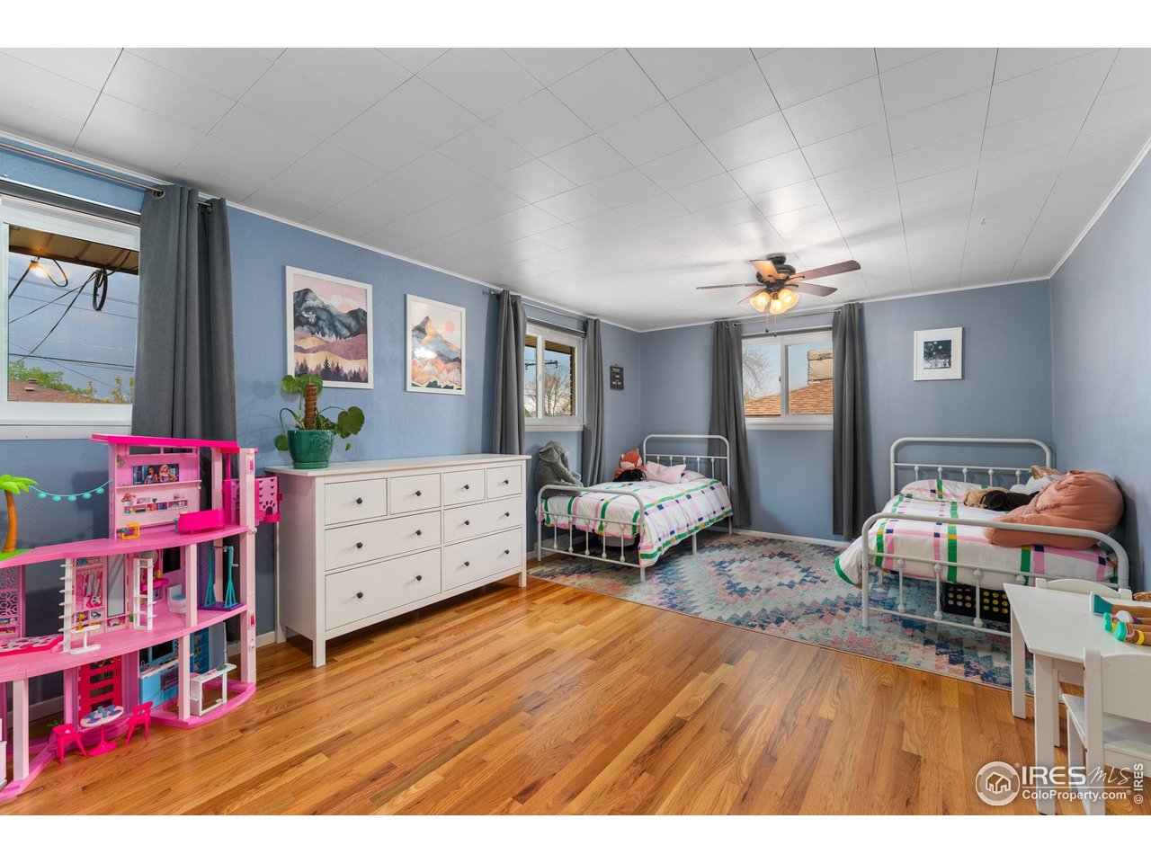 9261 Julian Way Westminster, CO 80031 - Photo 17 of 33 a bedroom with furniture and a wooden floor