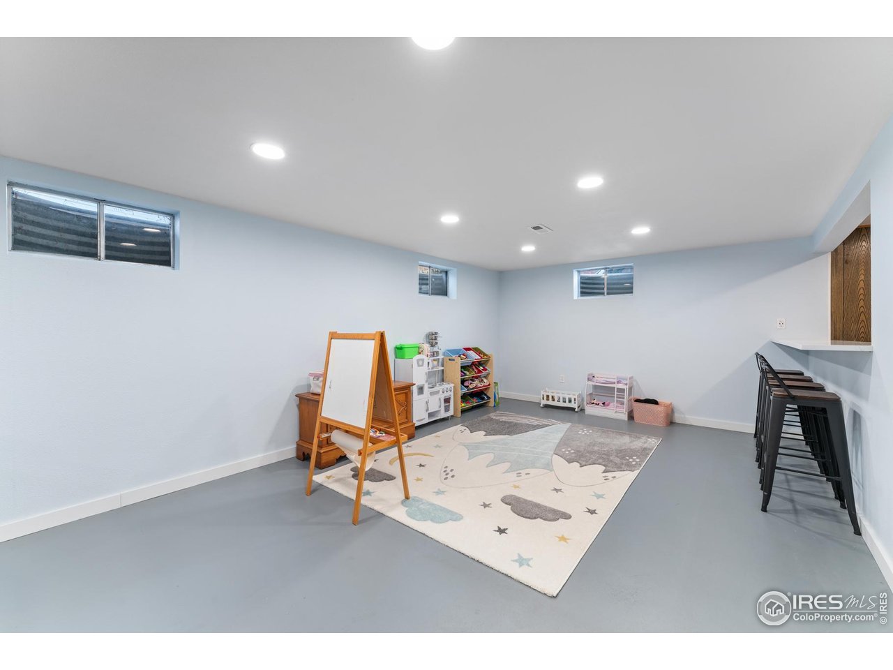 9261 Julian Way Westminster, CO 80031 - Photo 22 of 33 a living room with furniture and a flat screen tv