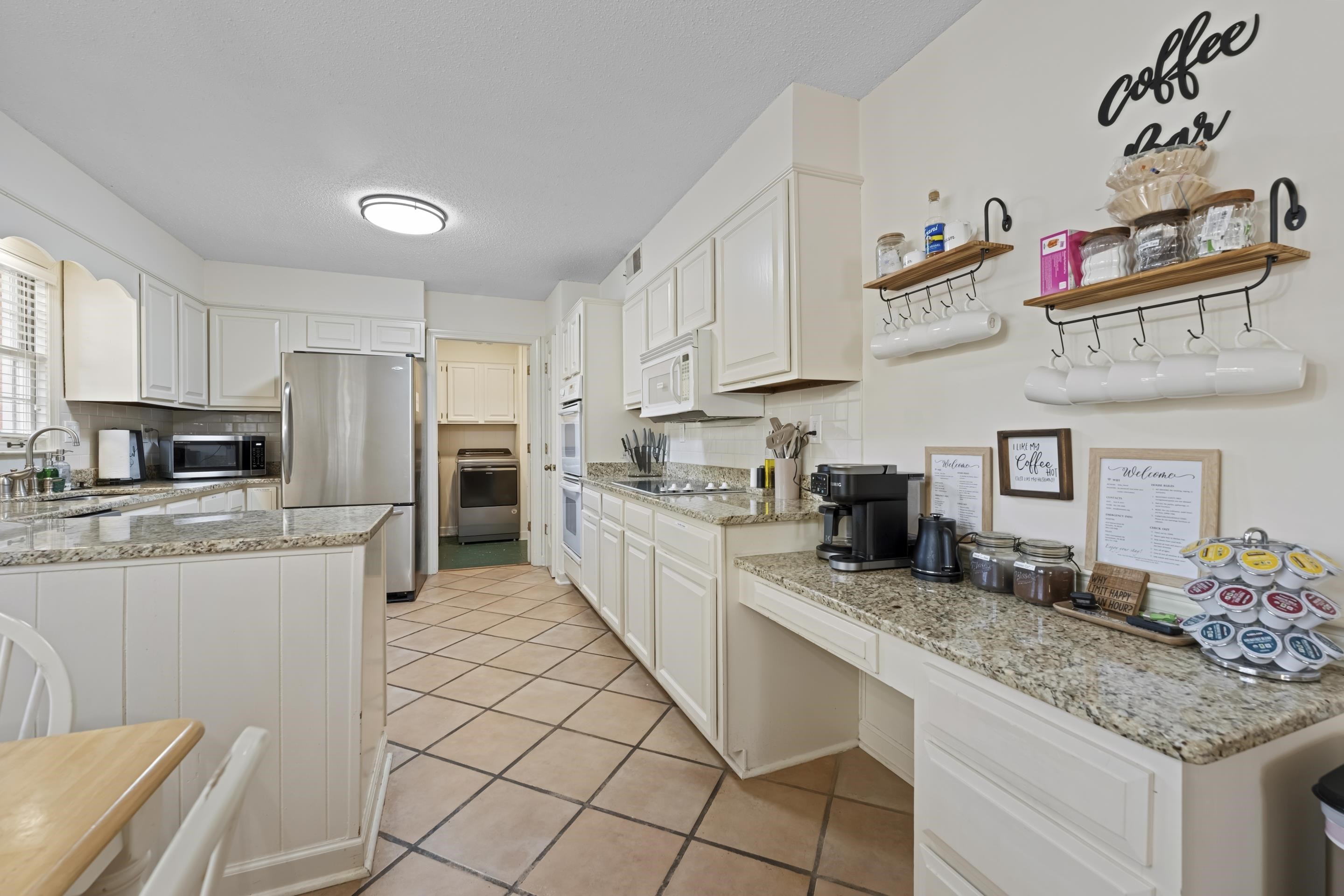 1316 Kirby Road Memphis, TN 38120 - Photo 14 of 30 a kitchen with granite countertop a sink stainless steel appliances and white cabinets